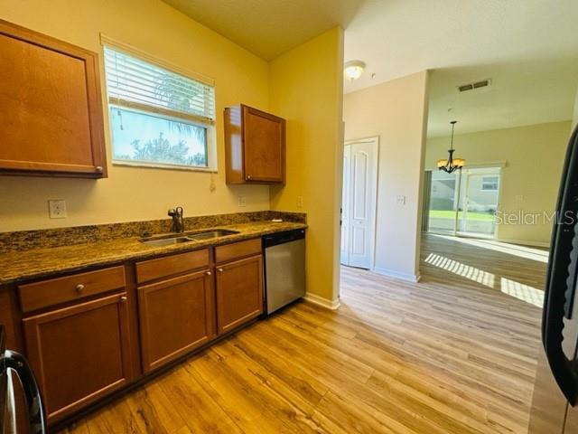 1276 Priory Circle Winter Garden, FL 34787 - Photo 15 of 37 a kitchen with stainless steel appliances granite countertop a sink and wooden cabinets