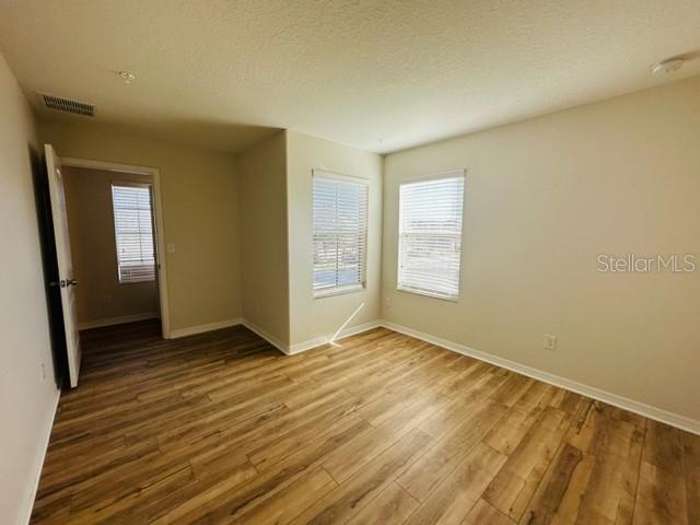 1276 Priory Circle Winter Garden, FL 34787 - Photo 25 of 37 an empty room with wooden floor and windows