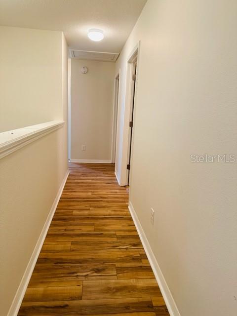 1276 Priory Circle Winter Garden, FL 34787 - Photo 29 of 37 a view of a hallway with wooden floor and staircase