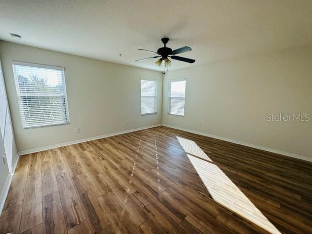 1276 Priory Circle Winter Garden, FL 34787 - Photo 35 of 37 a view of empty room with wooden floor and fan
