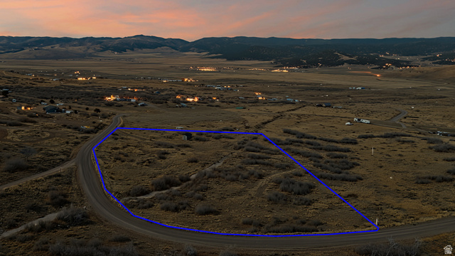 349 West Mountain View Road, Unit 349 Fairview, UT 84629 - Photo 25 of 26 Expansive undeveloped land parcel featuring a dirt road border, sparse natural vegetation, and distant mountain topography