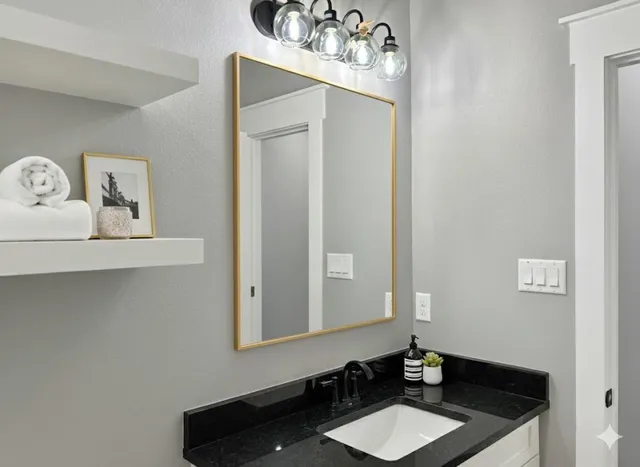 a bathroom with a sink vanity and a mirror