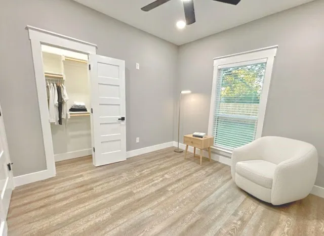 a spacious bedroom with a bed and a couch