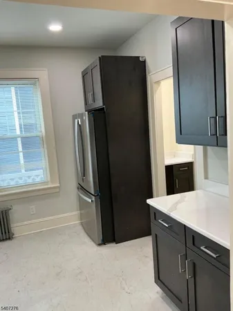 a kitchen with stainless steel appliances a refrigerator and a sink