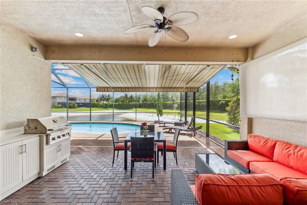 4360 Aurora Street Naples, FL 34119 - Photo 12 of 49 Covered outdoor lanai space with outdoor kitchen