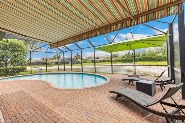 a swimming pool with outdoor seating