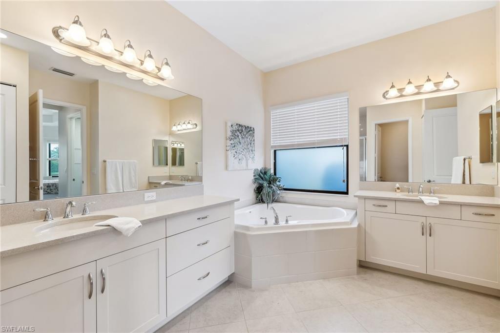 4360 Aurora Street Naples, FL 34119 - Photo 22 of 49 Primary ensuite bathroom with dual countertops, soaking tub