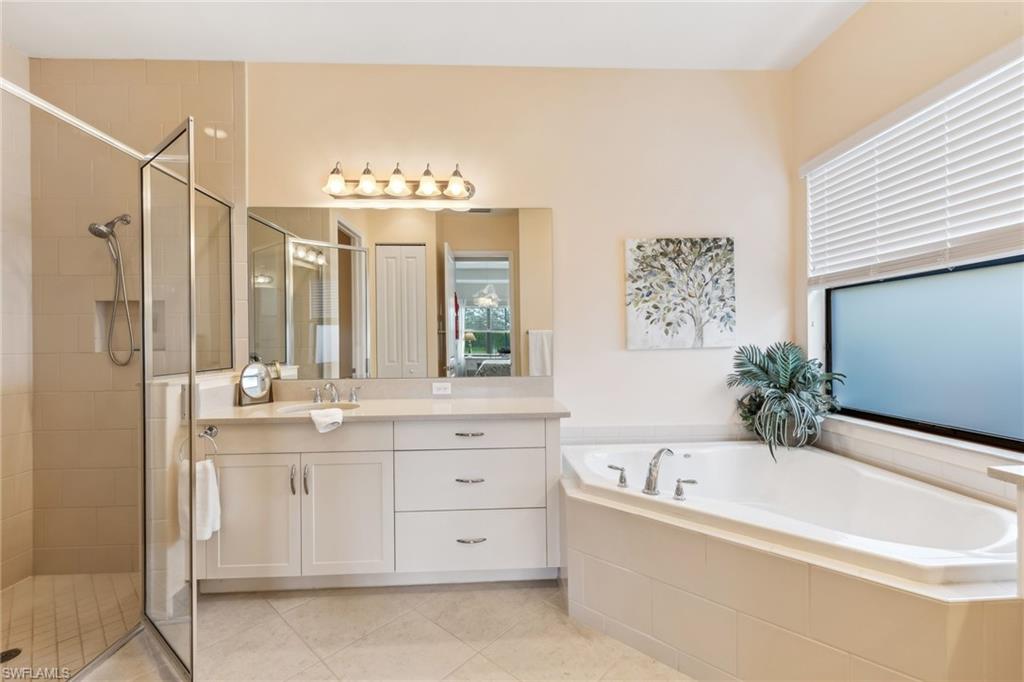 4360 Aurora Street Naples, FL 34119 - Photo 23 of 49 Primary bathroom with dual vanities, tub and shower