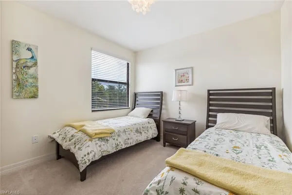 a bedroom with two beds and a window