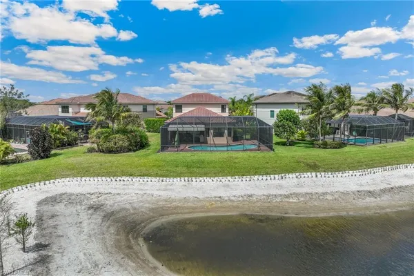a view of a house with a big yard and potted plants