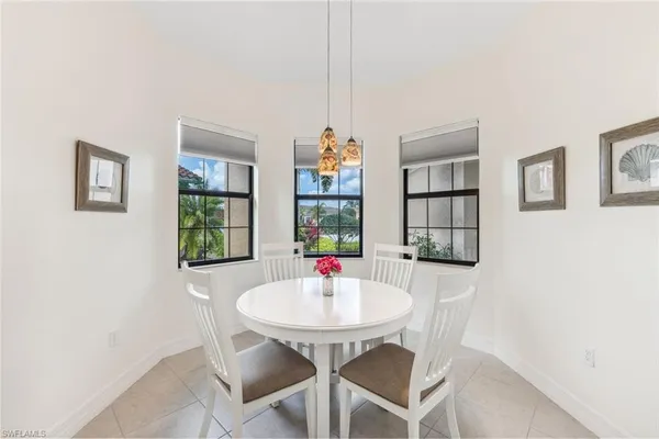 a dining room with furniture and window
