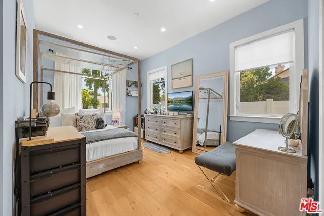 a bedroom with furniture and a window