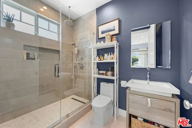 a bathroom with a toilet a sink and shower