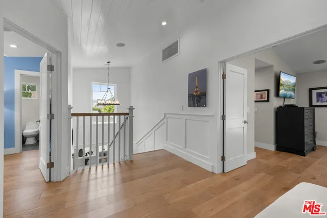 a spacious bedroom with a large bed and a large window