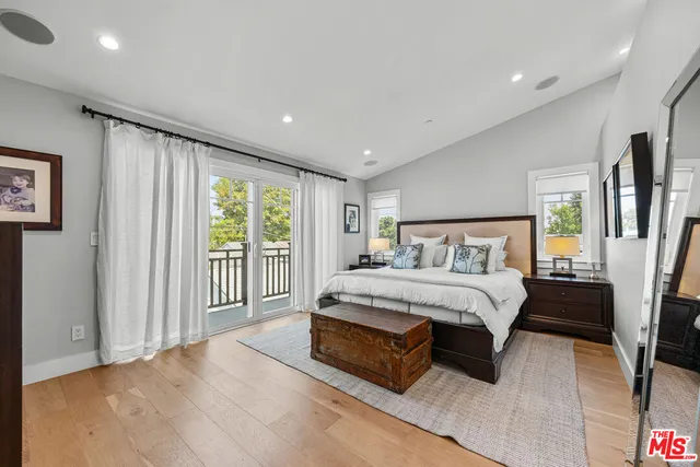 a spacious bedroom with a bed and a view of bathroom