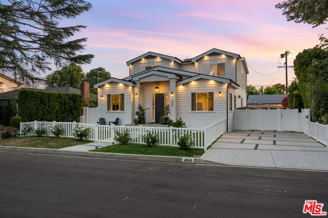 a front view of a house with a garden