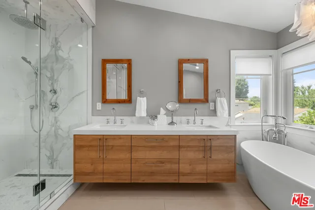 a bathroom with a tub sink and mirror