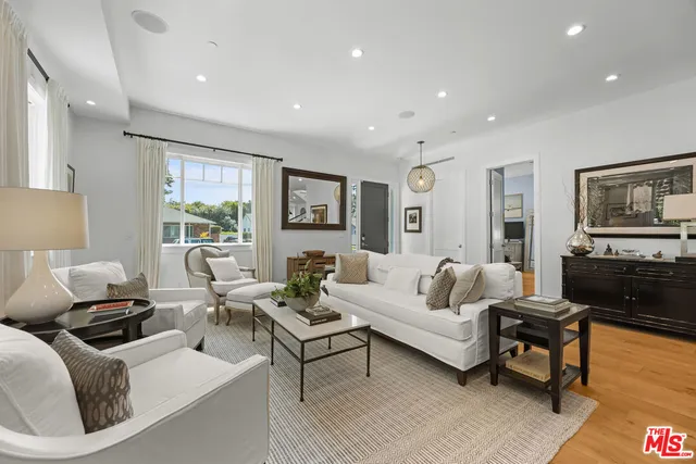 a living room with furniture wooden floor and a flat screen tv