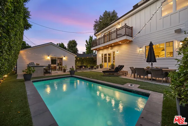 a view of a house with backyard stove and sitting area