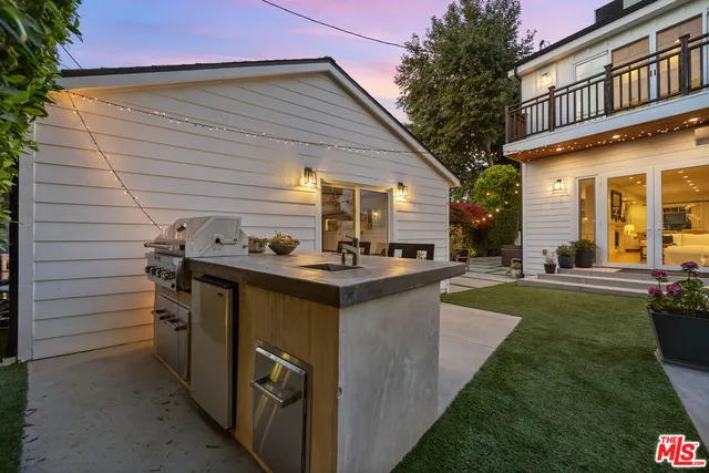 a house view with a sitting space fire pit and outdoor space