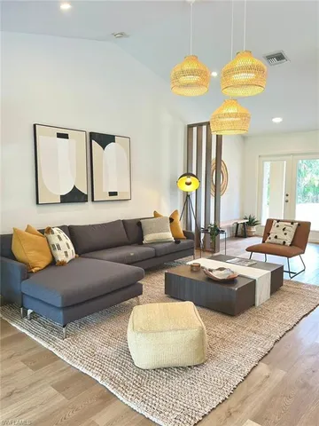 a living room with couches and kitchen view