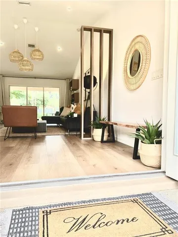 a bedroom with furniture and a large window