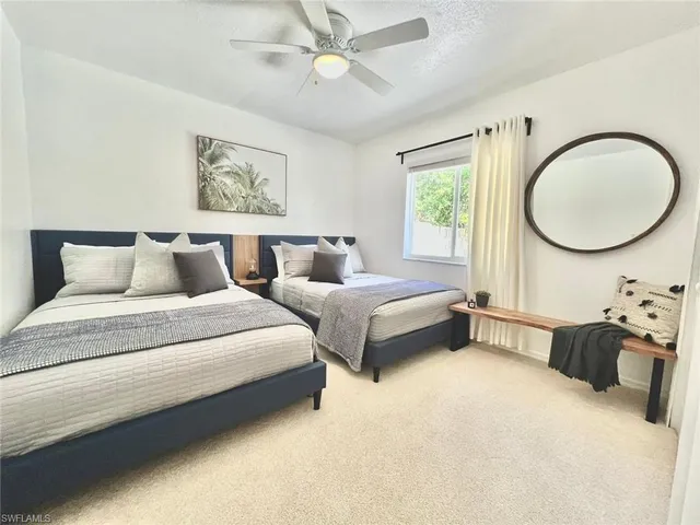 a bedroom with bed and a chandelier