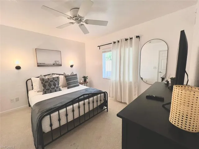a bedroom with a white bed and white walls