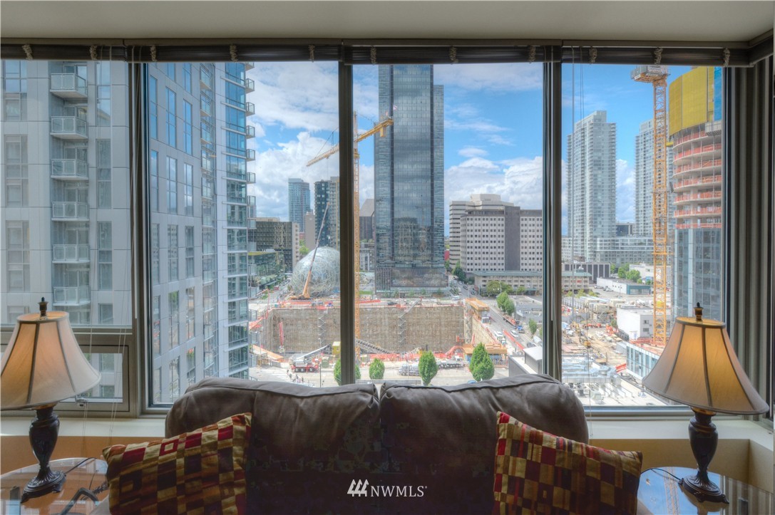 900 Lenora Street, Unit W1105 Seattle, WA 98121 - Photo 11 of 25 a living room filled with furniture and a floor to ceiling window