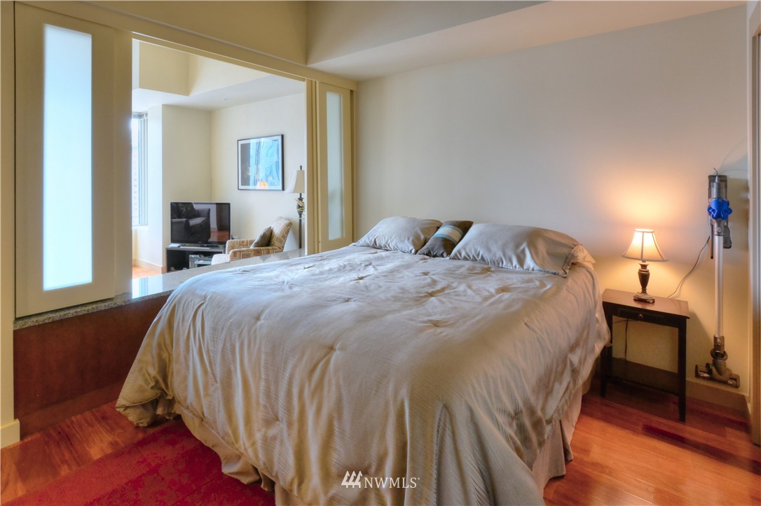 900 Lenora Street, Unit W1105 Seattle, WA 98121 - Photo 13 of 25 a bedroom with a bed and a mirror