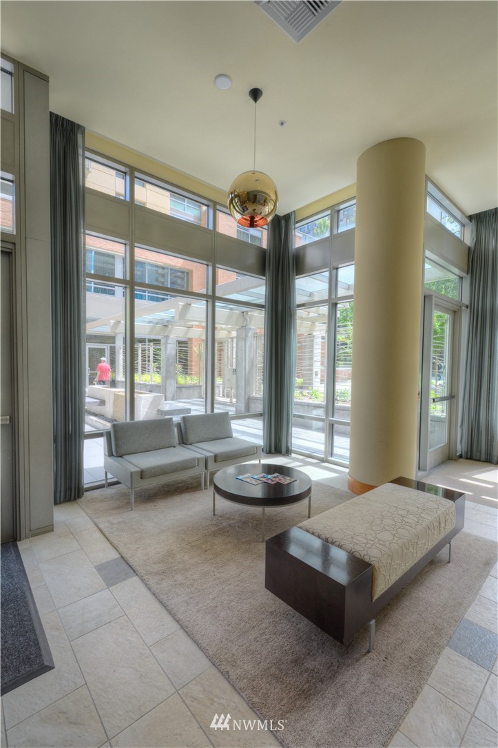 900 Lenora Street, Unit W1105 Seattle, WA 98121 - Photo 17 of 25 a living room with furniture and large windows