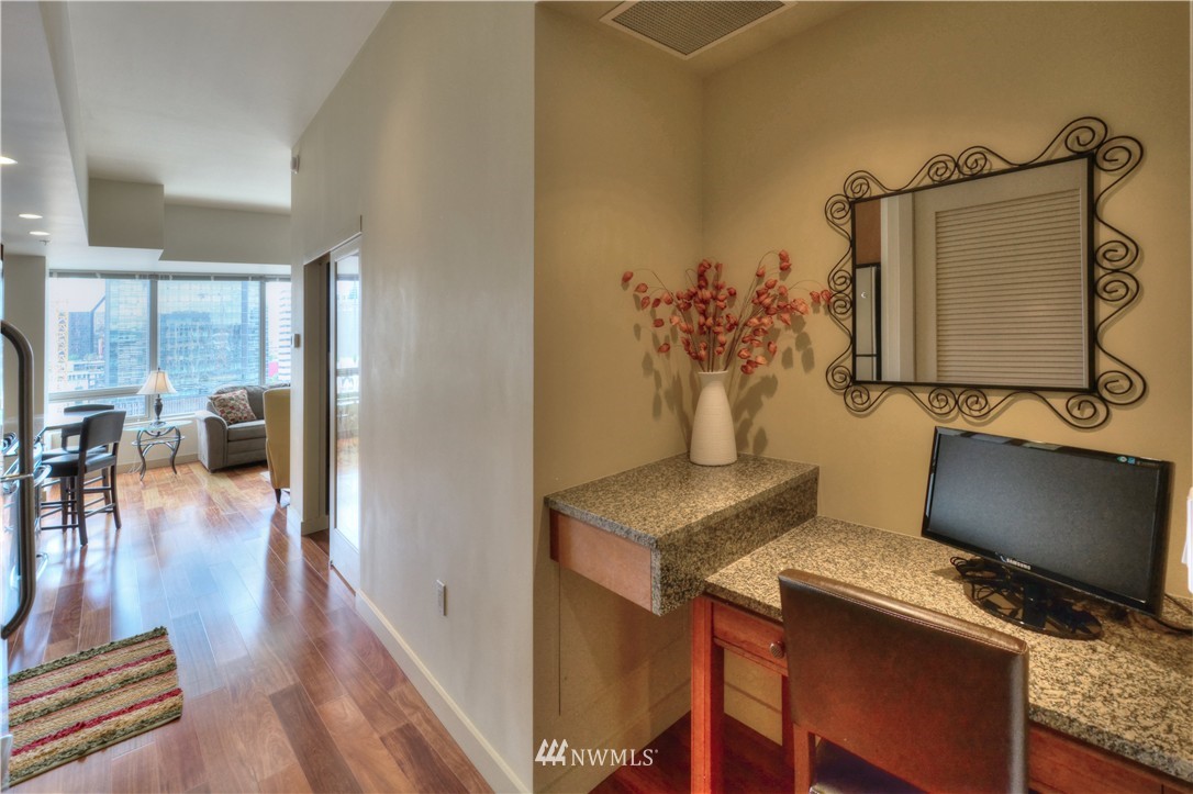 900 Lenora Street, Unit W1105 Seattle, WA 98121 - Photo 3 of 25 a view of workspace with wooden floor outdoor seating and kitchen view