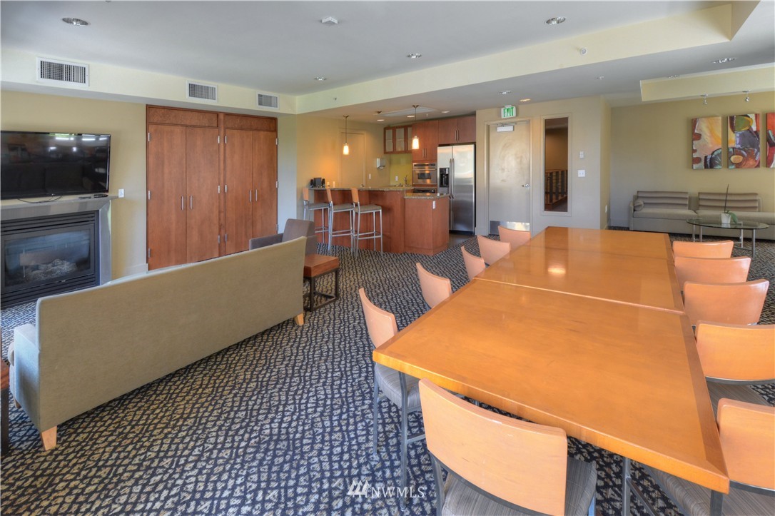 900 Lenora Street, Unit W1105 Seattle, WA 98121 - Photo 24 of 25 a living room with stainless steel appliances with kitchen view