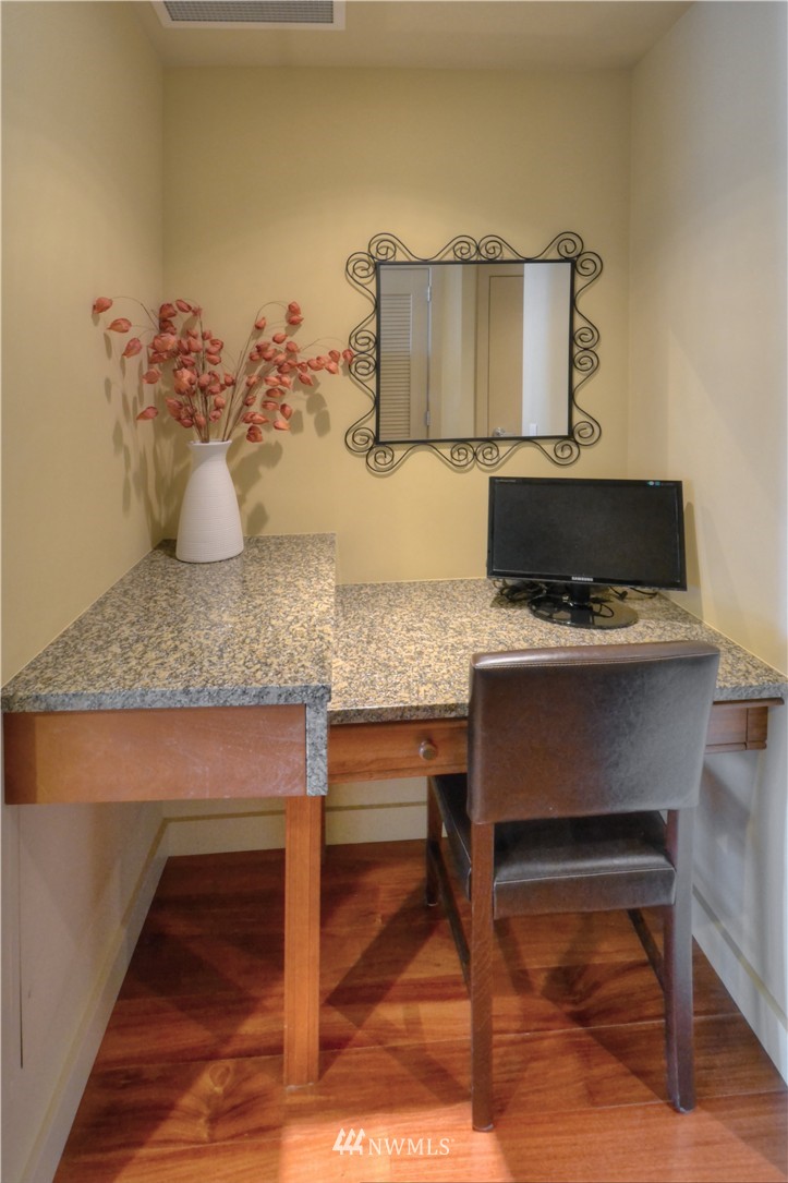 900 Lenora Street, Unit W1105 Seattle, WA 98121 - Photo 4 of 25 a view of a kitchen with granite countertop and chairs in it