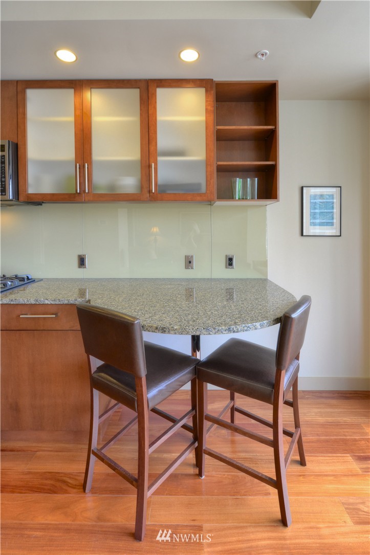 900 Lenora Street, Unit W1105 Seattle, WA 98121 - Photo 7 of 25 a view of a kitchen with a table and chairs