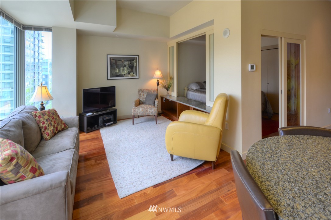 900 Lenora Street, Unit W1105 Seattle, WA 98121 - Photo 8 of 25 a living room with furniture rug and window