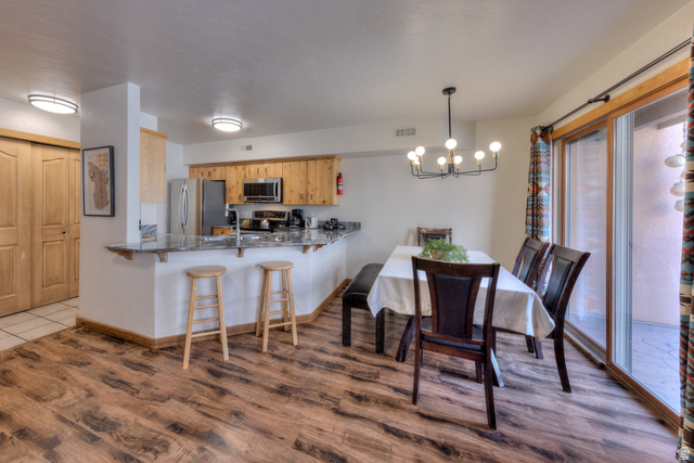 3461 Westwater Road, Unit 6 Moab, UT 84532 - Photo 10 of 33 Dining room featuring hanging lights and dark wood-type flooring