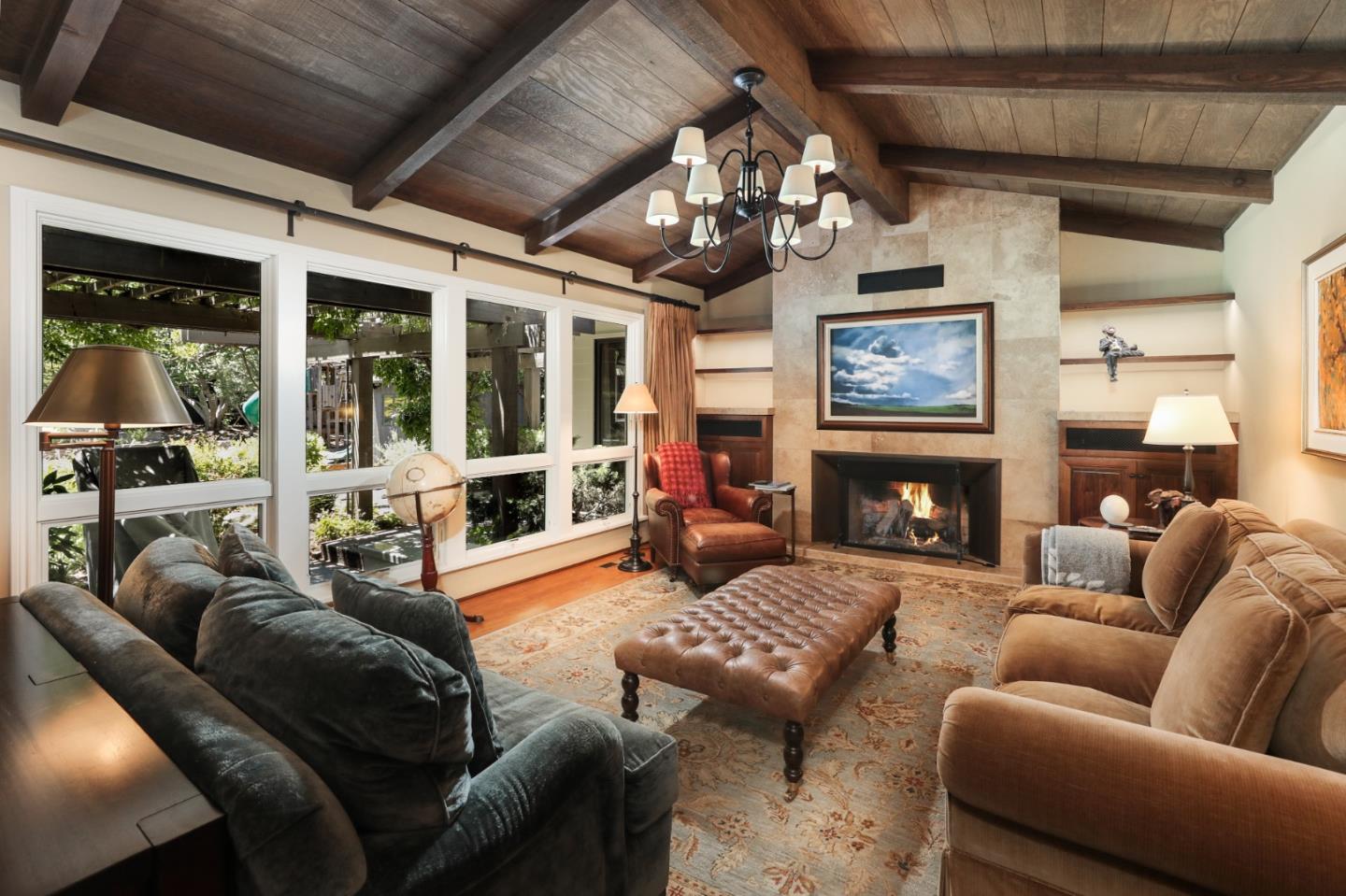 285 Ridgeway Road Woodside, CA 94062 - Photo 11 of 18 a living room with furniture a fireplace and a chandelier