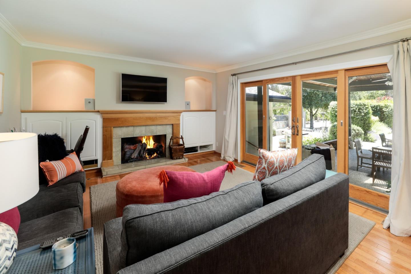 285 Ridgeway Road Woodside, CA 94062 - Photo 14 of 18 a living room with furniture flat screen tv and a fireplace