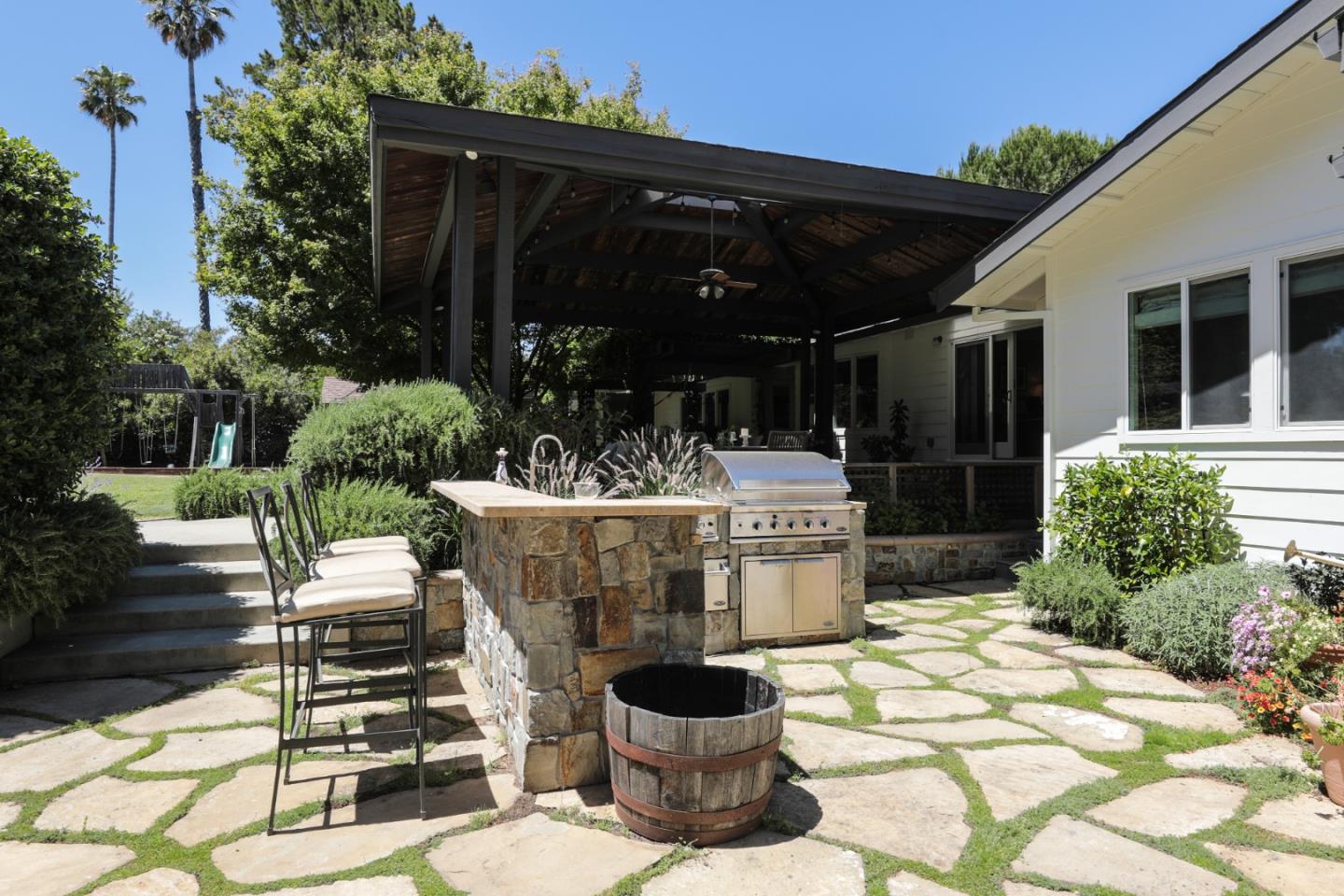 285 Ridgeway Road Woodside, CA 94062 - Photo 4 of 18 a view of a patio with table and chairs potted plants and floor to ceiling window