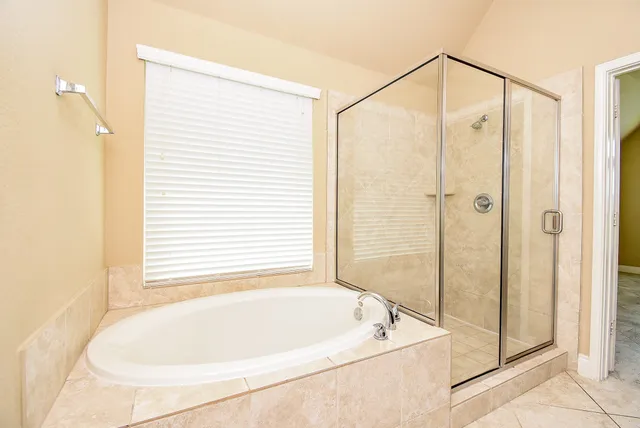 a bathroom with a bathtub and a shower