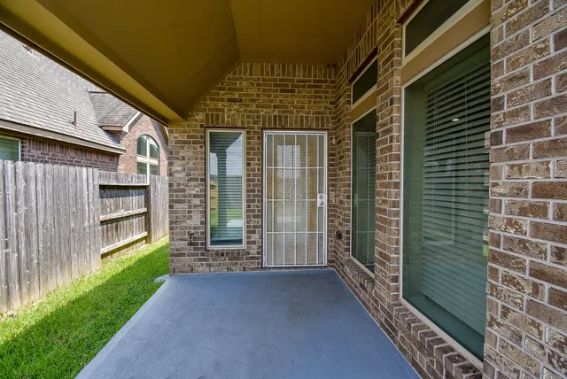 a view of a brick house with a large window