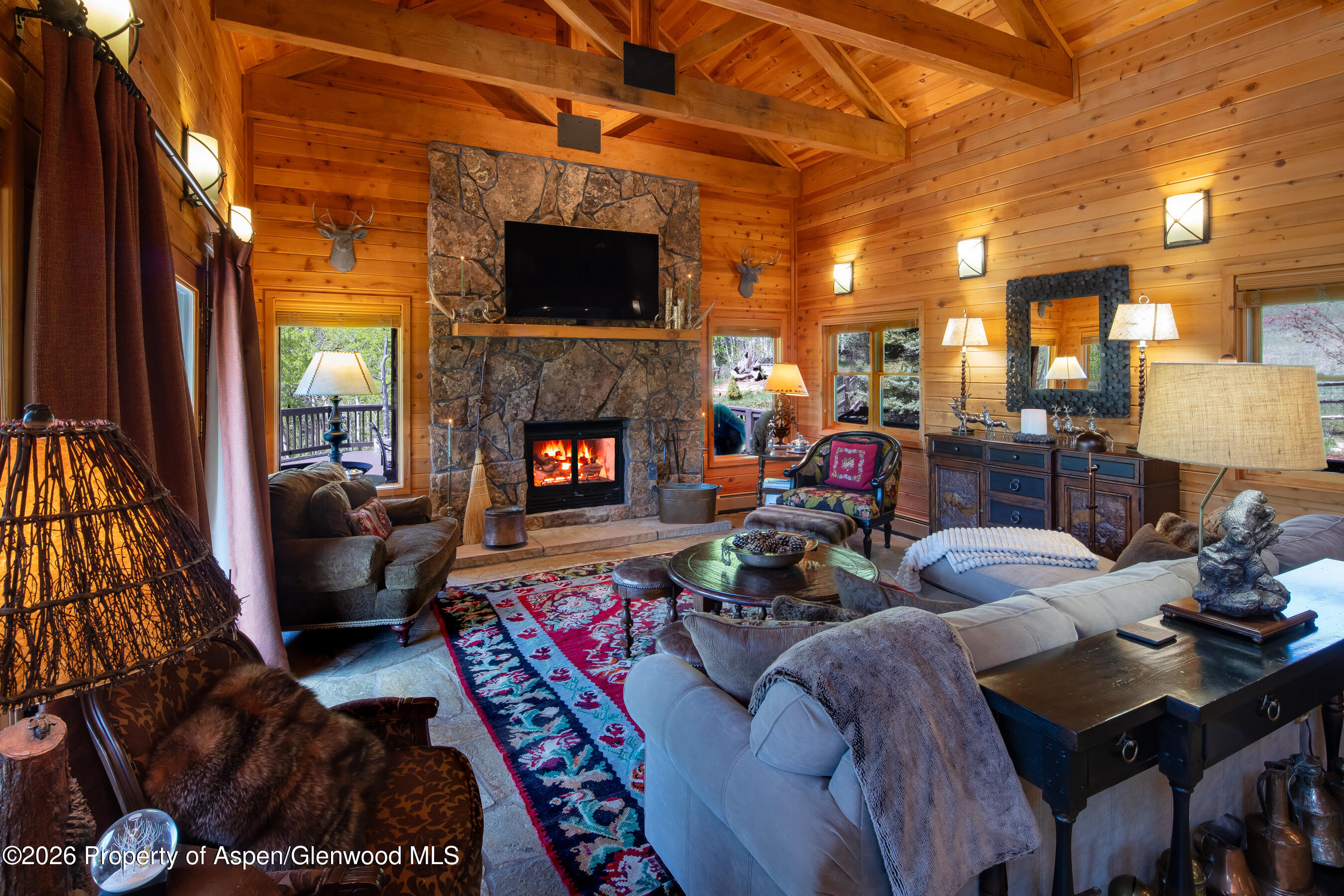 294 Ruedi Creek Road Basalt, CO 81621 - Photo 9 of 27 a living room with furniture and a fireplace