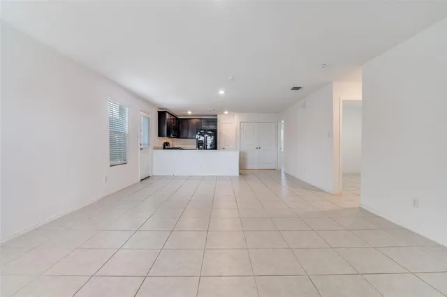 a view of a big room with closet and windows