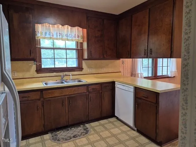 a kitchen with a sink cabinets and window