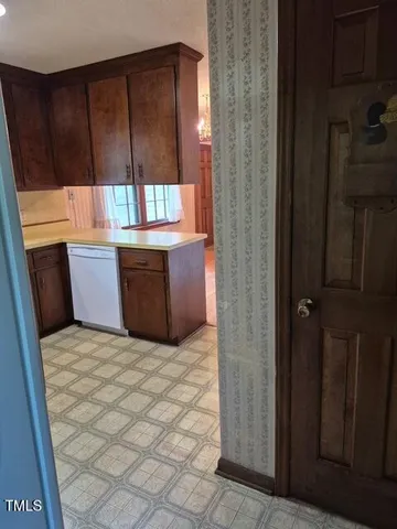 a view of kitchen with granite countertop cabinets and sink