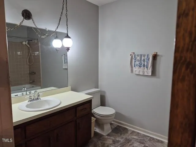 a bathroom with a sink vanity mirror and toilet