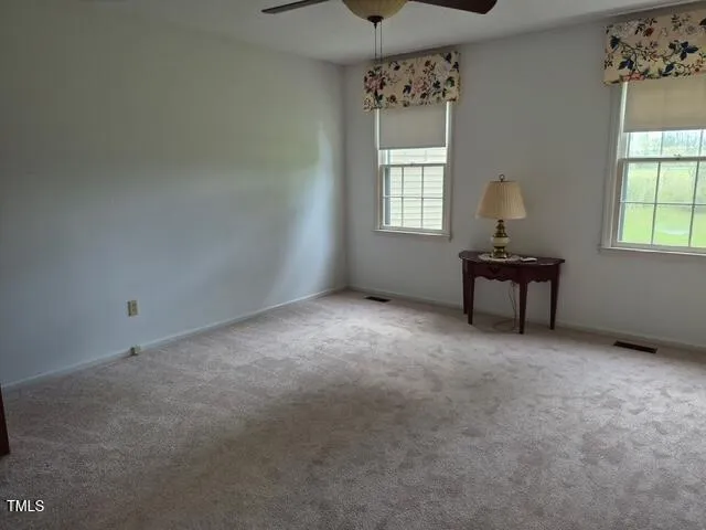 an empty room with windows and closet