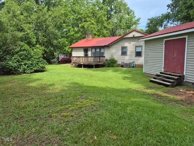 a view of a house with a yard and sitting area