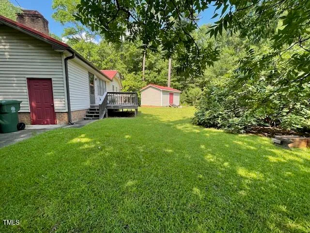 a backyard of a house with table and chairs
